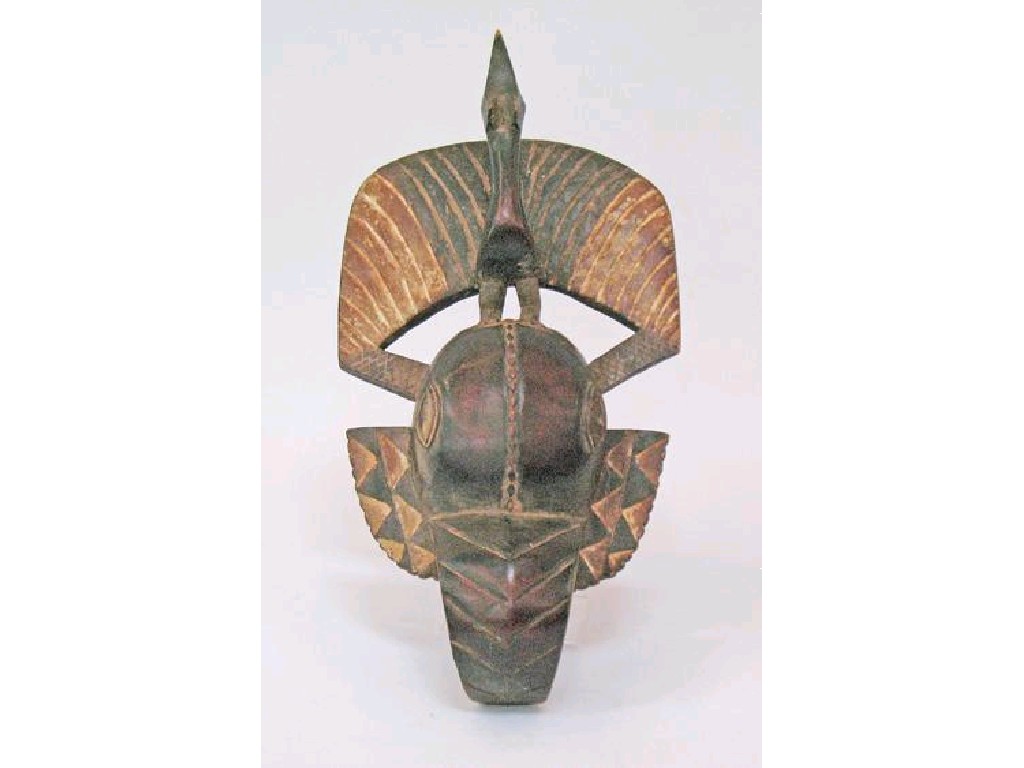 Appraisal: A CARVED AFRICAN MASK OF A STYLISED ELEPHANT surmounted by