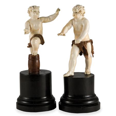 Appraisal: Pair of German Ivory and Walnut Figures Estimate -