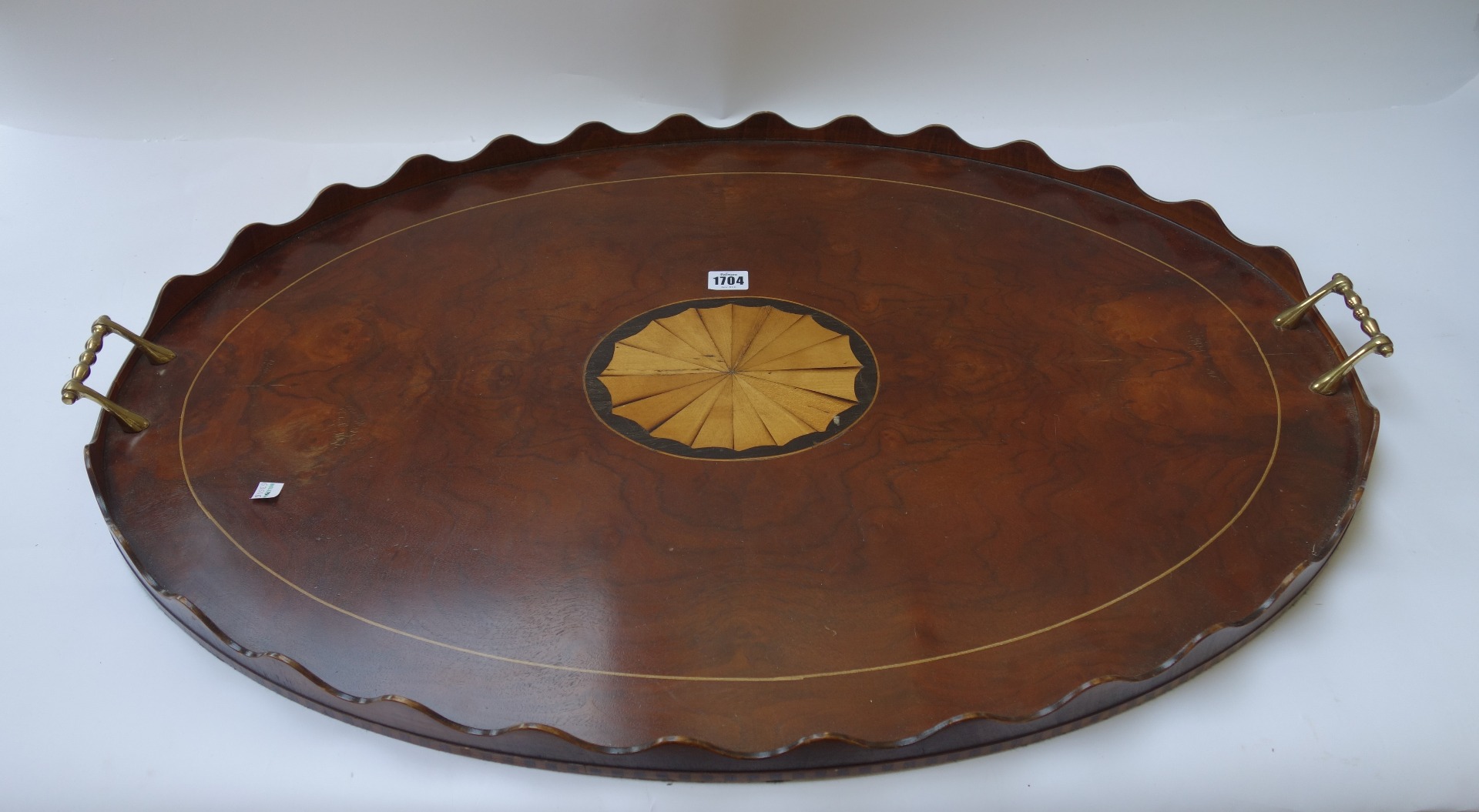 Appraisal: A large marquetry inlaid walnut oval serving tray with wavy