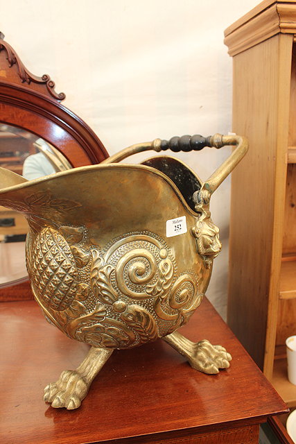 Appraisal: A VICTORIAN BRASS COAL BUCKET with embossed scrolling decoration lion