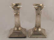 Appraisal: A pair of silver Corinthian column candlesticks ht cm London