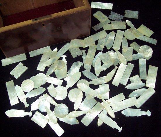 Appraisal: A quantity of mother-of-pearl gaming tokens various including fish shaped