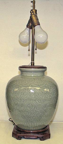 Appraisal: A celadon glazed ovoid porcelain globular jar With carved dragon