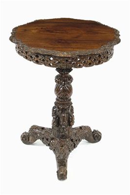 Appraisal: A Burmese carved rosewood occasional table the shaped tilt-top to