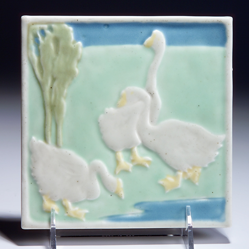 Appraisal: ROOKWOOD Trivet embossed with three white geese on a verdant