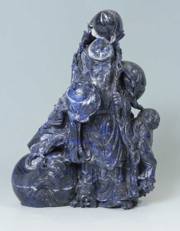 Appraisal: CHINESE CARVED DEITY CHILD SOAPSTONE GROUP Deep blue figure of