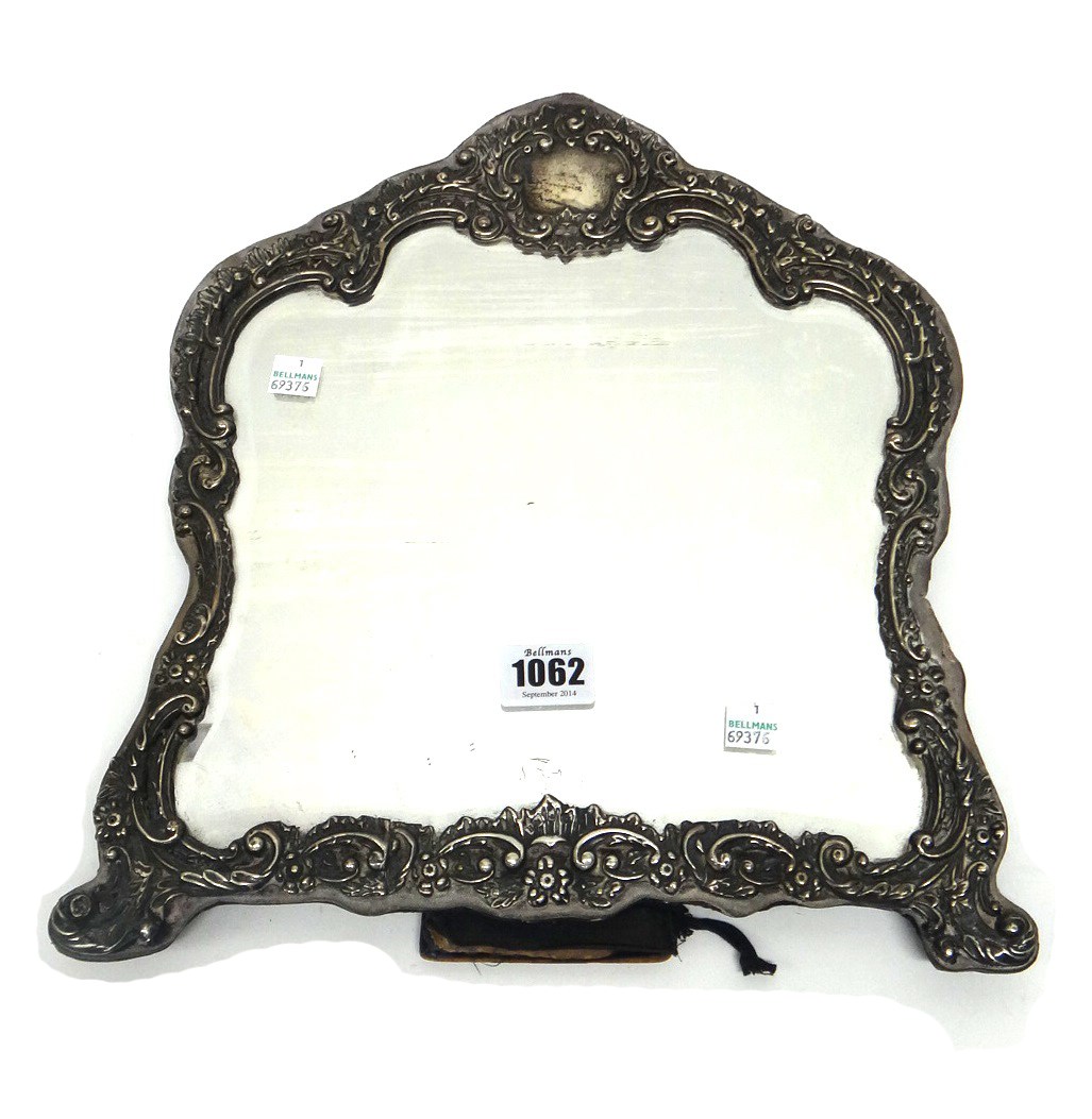 Appraisal: A silver mounted shaped rectangular strut backed mirror with a