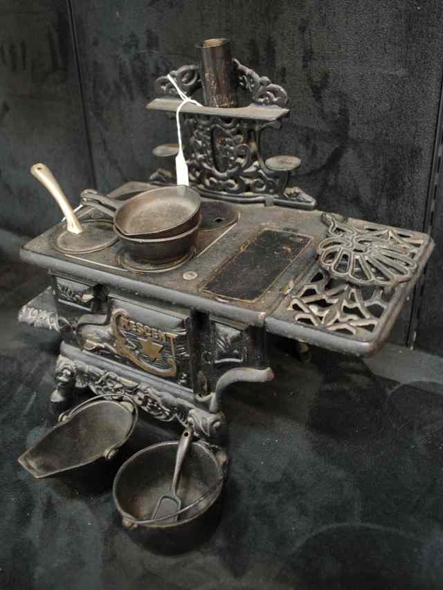 Appraisal: A CRESCENT CAST IRON TOY STOVE with attached side mounts