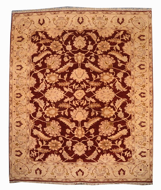 Appraisal: A PAKISTANI PERSIAN STYLE RED GROUND CARPET with pastel foliate