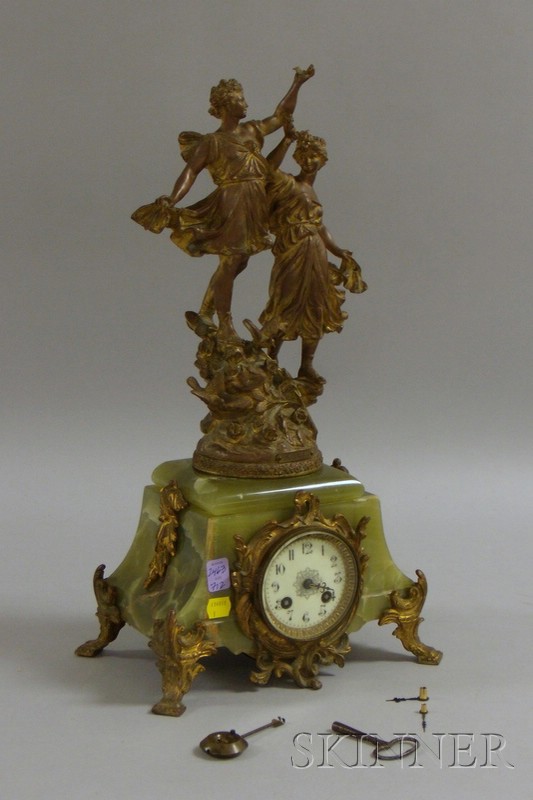 Appraisal: French Gilt-bronze and Onyx Figural Clock with eight-day time and