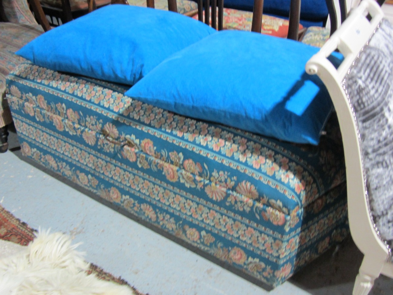 Appraisal: A blue upholstered ottoman