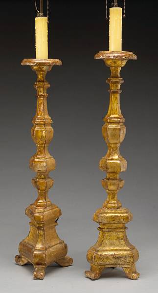 Appraisal: A pair of Italian Baroque giltwood candlesticks Tuscany th century