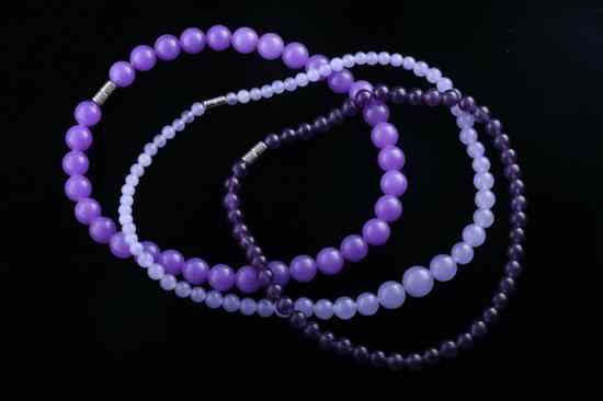 Appraisal: THREE HARDSTONE BEAD NECKLACES Various shades of lavender