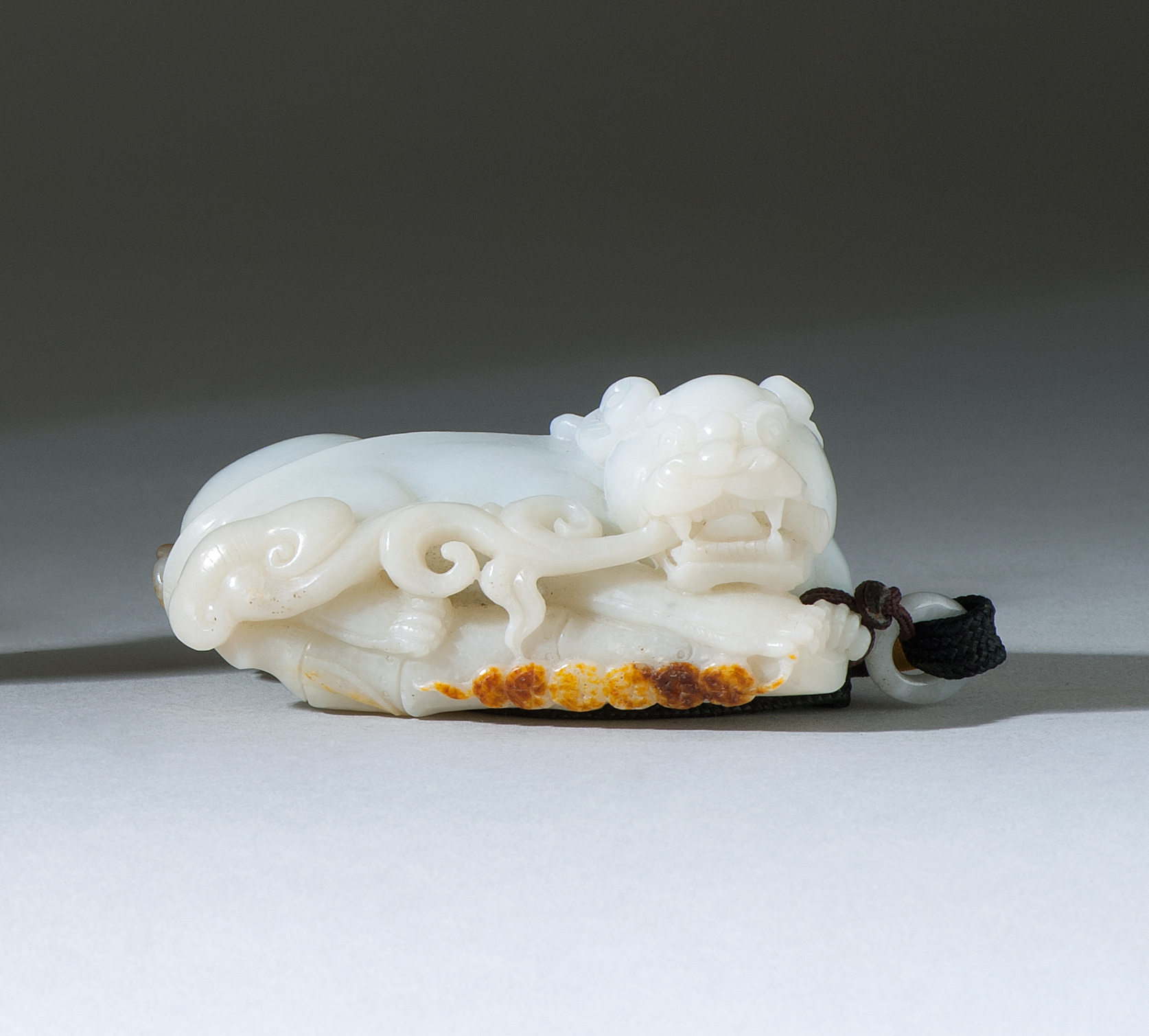 Appraisal: WHITE AND RUSSET JADE PENDANT In the form of a