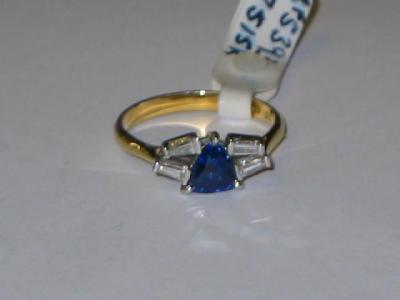 Appraisal: A SAPPHIRE AND DIAMOND RING the triangular cut sapphire claw