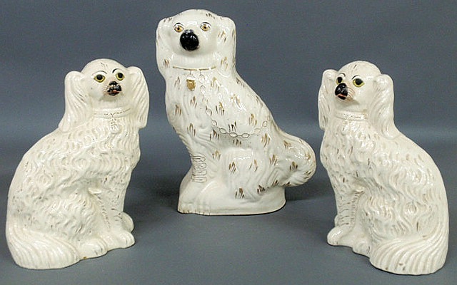 Appraisal: Pair of th c Staffordshire white seated Spaniels h and