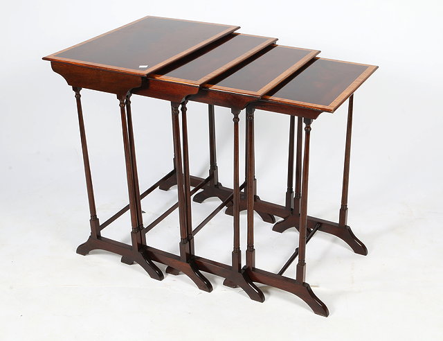 Appraisal: A NEST OF FOUR MAHOGANY RECTANGULAR TOPPED OCCASIONAL TABLES with