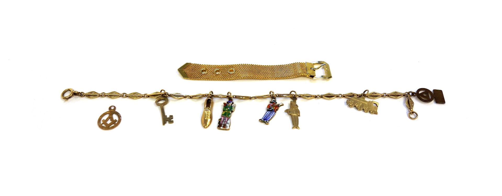 Appraisal: A charm bracelet fitted with seven mostly gold charms including