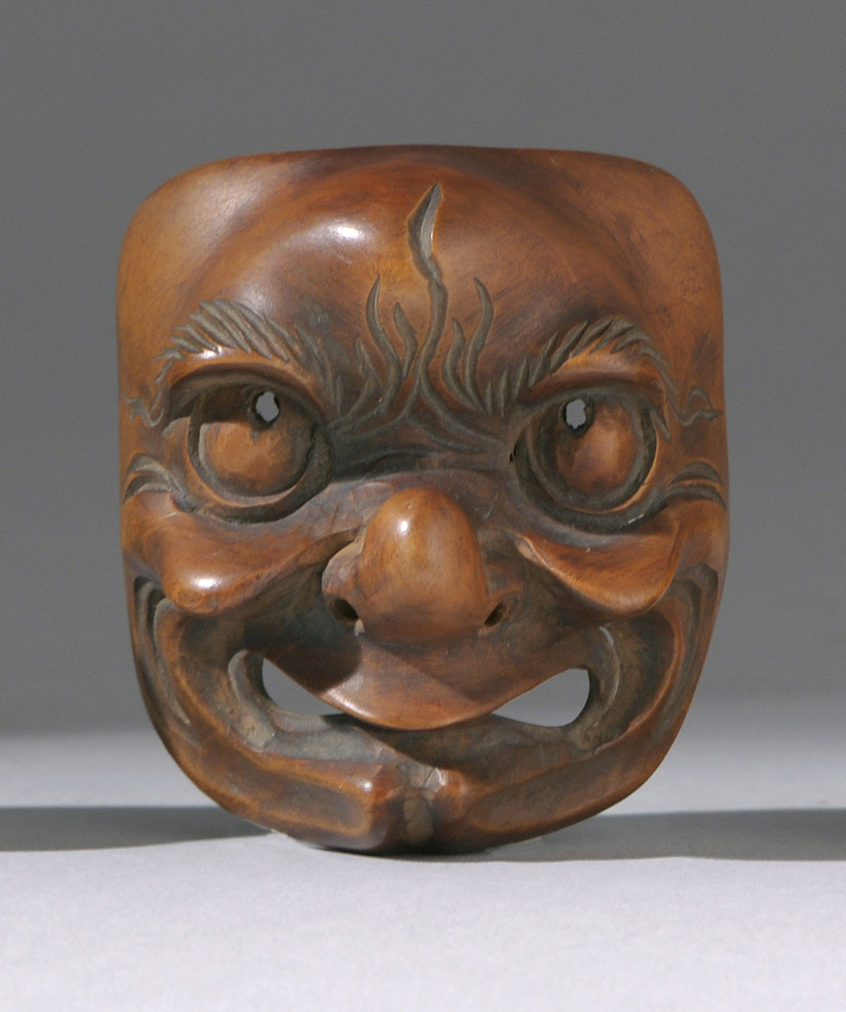 Appraisal: WOOD MASK NETSUKE Early th CenturyDepicting a comic figure with