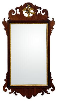 Appraisal: Chippendale mahogany looking glass scrolled mirror surround centering a pierce-carved