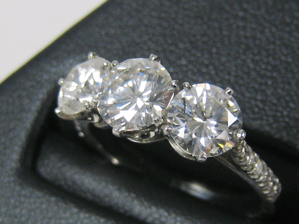 Appraisal: A Diamond three stone Ring claw-set brilliant-cut stones diamond chips