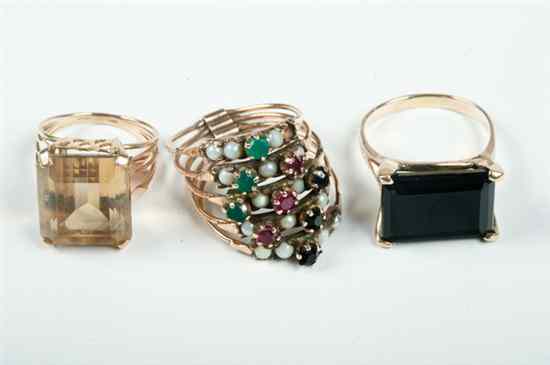 Appraisal: THREE K YELLOW GOLD AND COLORED GEMSTONE RINGS One with