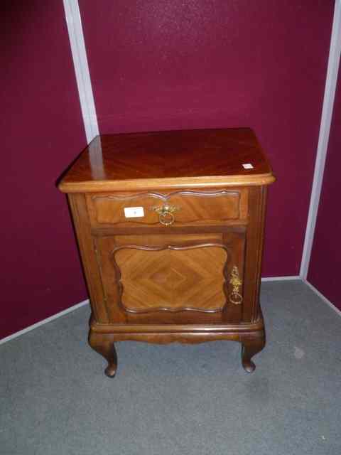 Appraisal: A WALNUT BEDSIDE LOCKER fitted with cupboards and drawer with