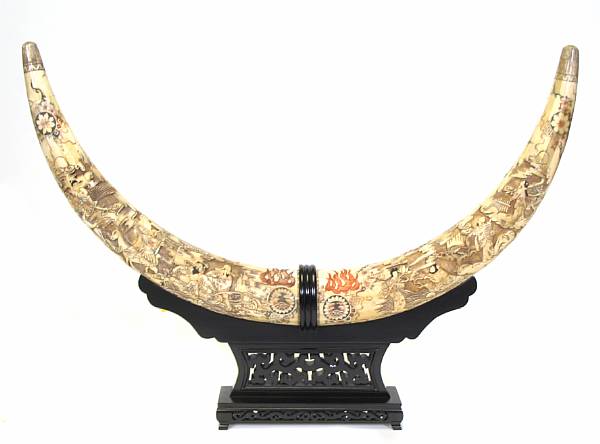 Appraisal: A pair of Chinese carved bone veneer tusks on stand