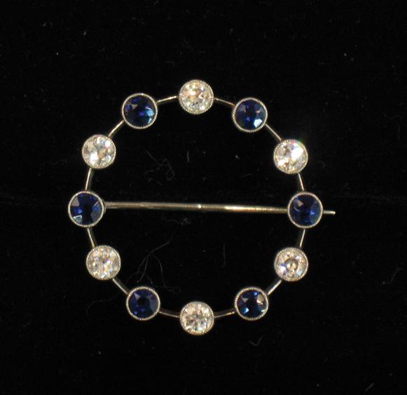 Appraisal: A DIAMOND AND SAPPHIRE BROOCH of open wreath form interspersed