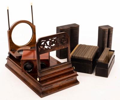 Appraisal: A Victorian walnut cased stereoscopic viewer and two boxes of