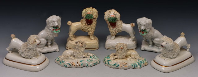 Appraisal: Pair of porcelain model poodleslate th Century on green and