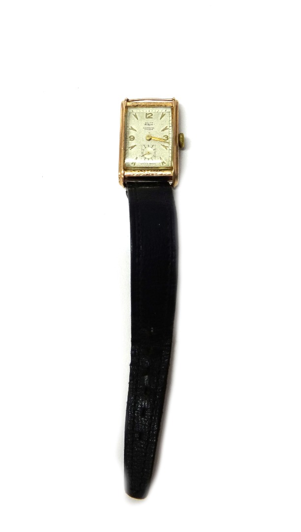 Appraisal: A gentleman's gold rectangular cased wristwatch the signed dial with