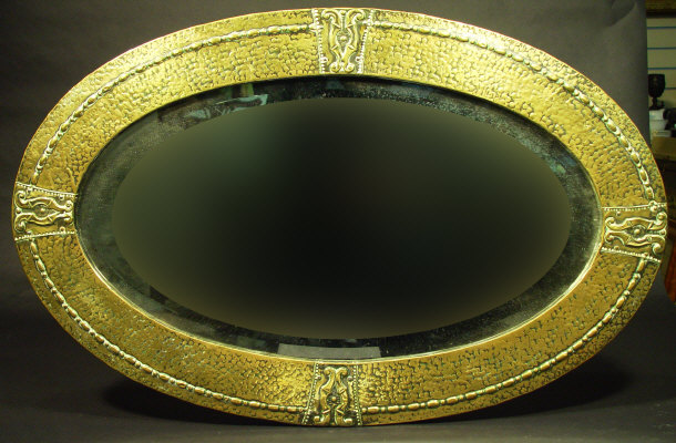 Appraisal: Art Nouveau oval brass framed mirror with hammered and embossed