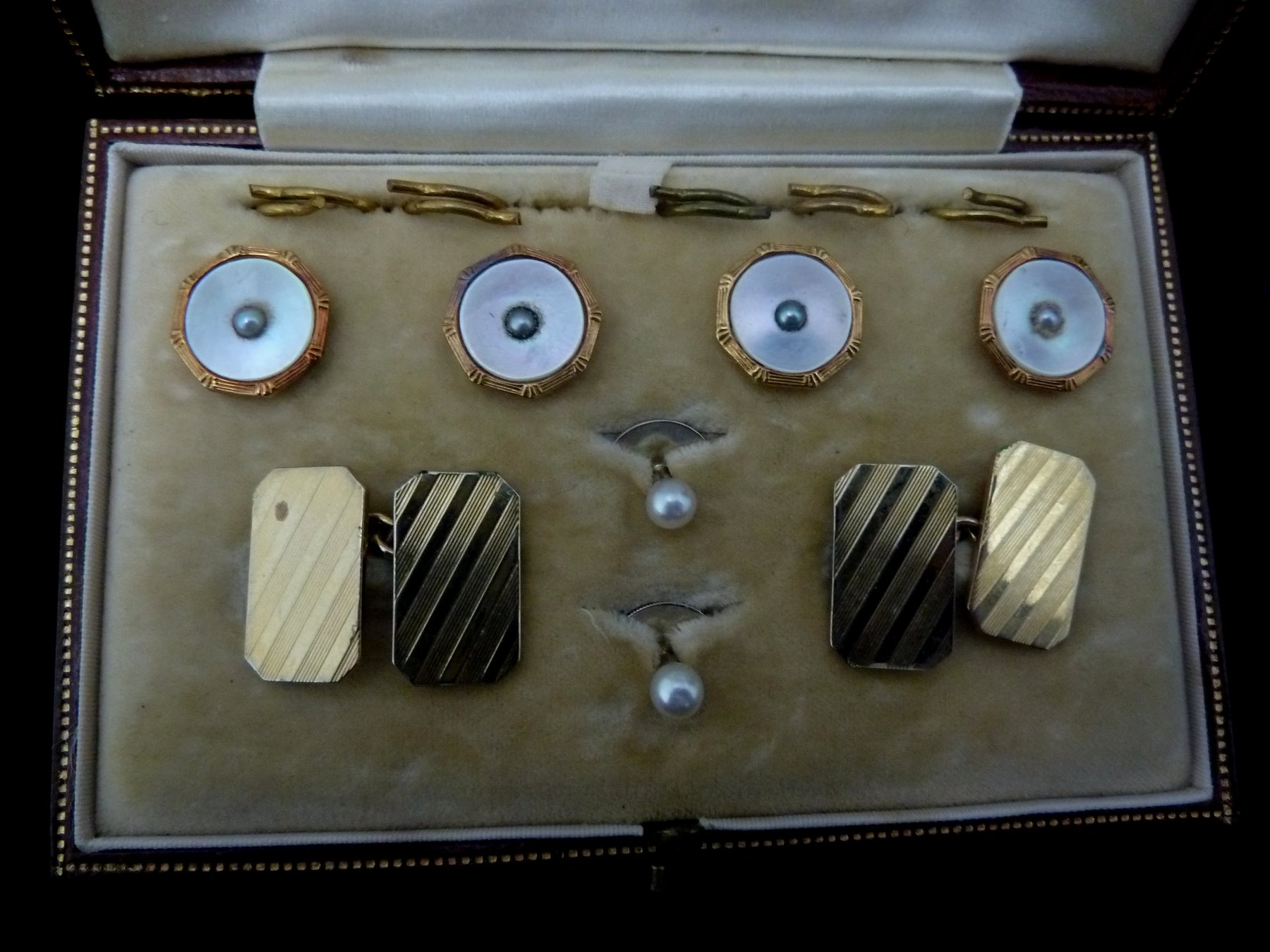 Appraisal: A gentleman's dress set comprising four mother-of-pearl buttons each with