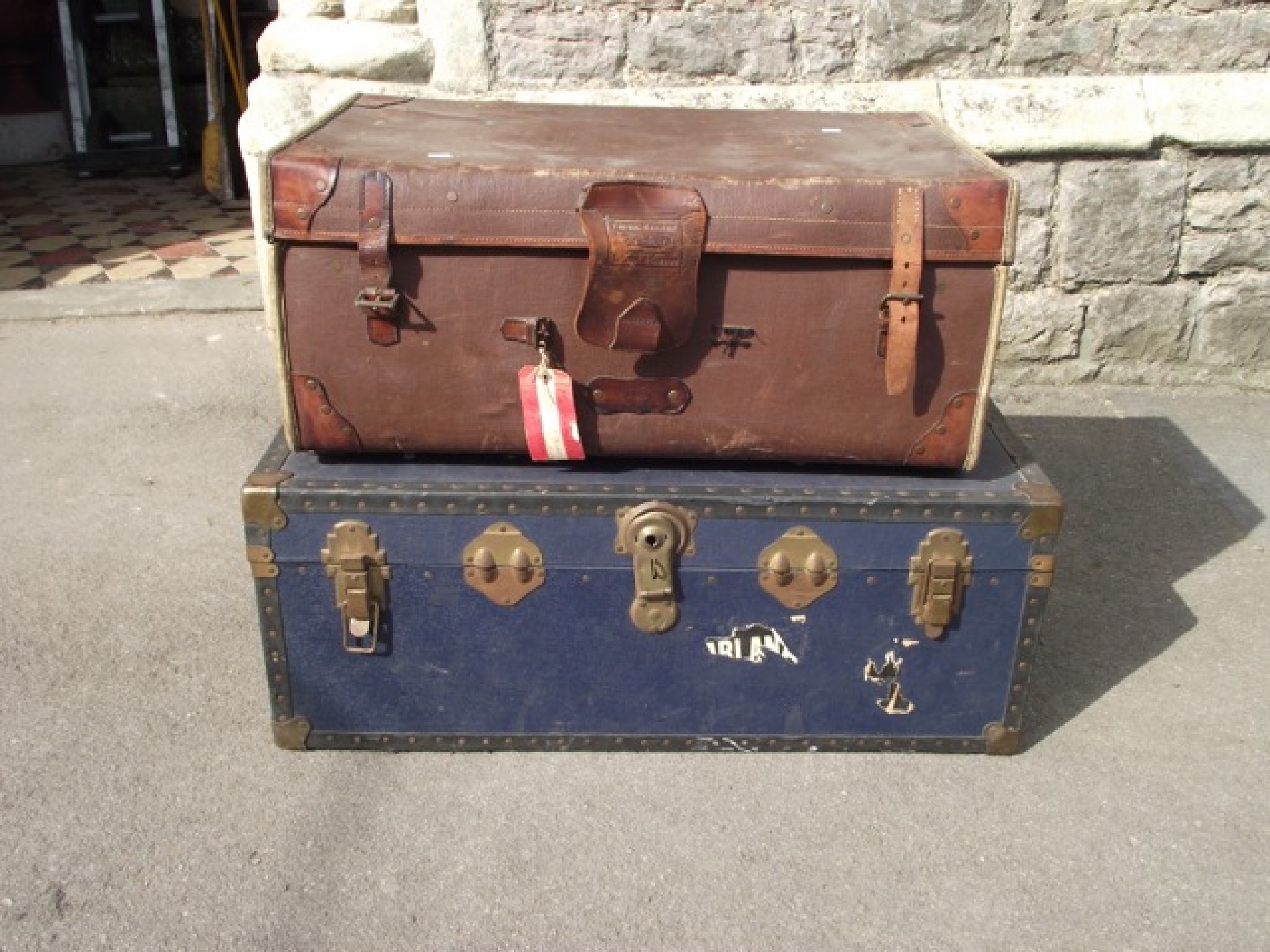 Appraisal: A vintage brown fibre and leather reinforced travelling trunk labelled