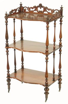 Appraisal: A Victorian rosewood serpentine front three tier etagere having a