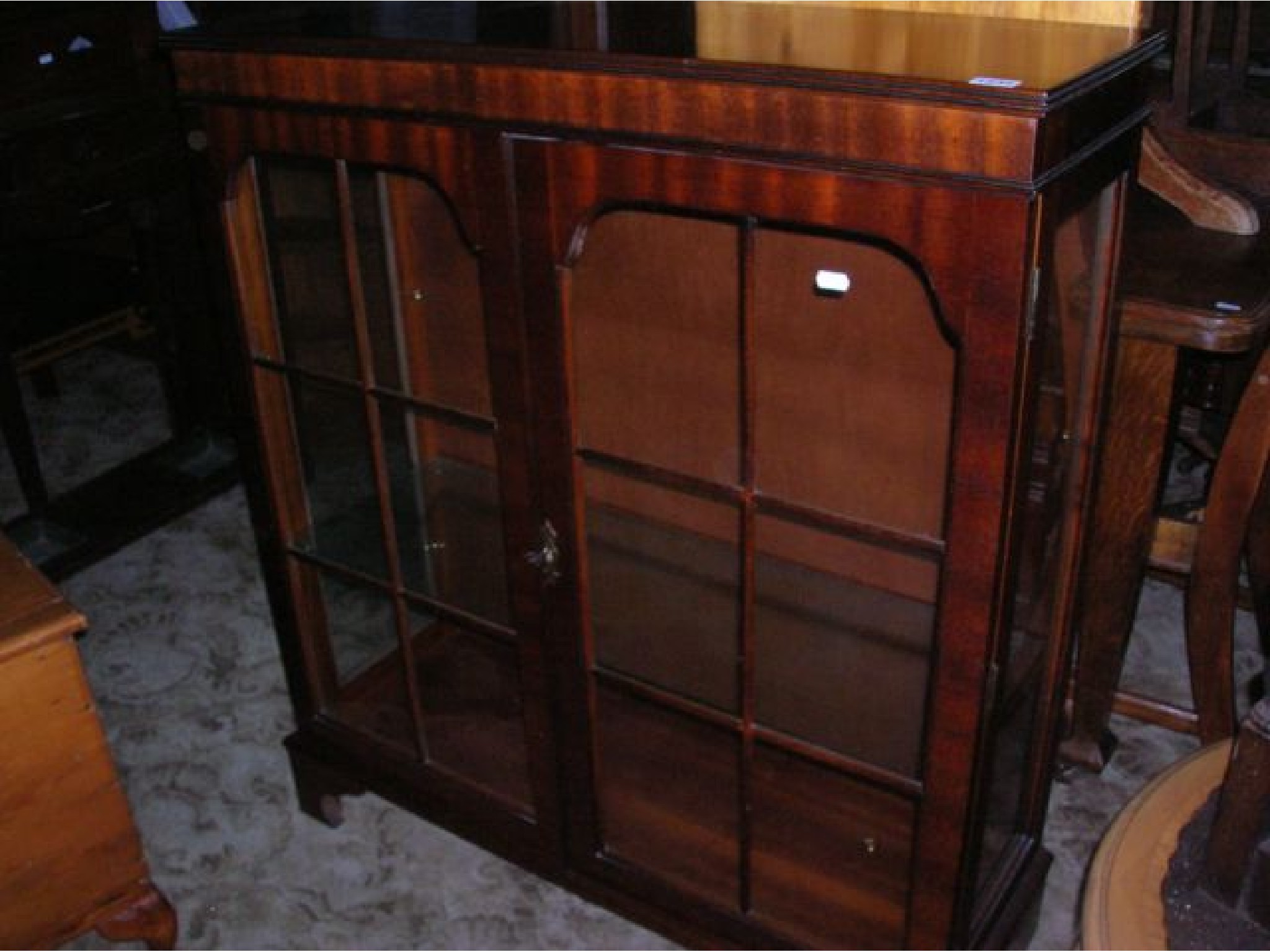 Appraisal: A reproduction mahogany display cabinet in the Georgian style enclosed