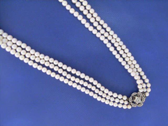 Appraisal: A graduating - mm three strand cultured pearl necklace with