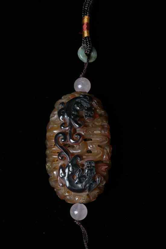 Appraisal: CHINESE AGATE RETICULATED PENDANT Carved to depict confronting dragons chasing