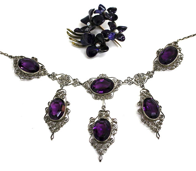 Appraisal: A PASTE AMETHYST TYPE STONE WHITE METAL NECKLACE with scroll