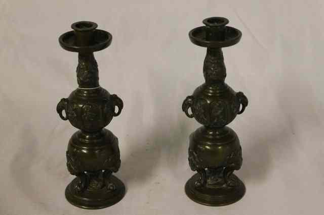 Appraisal: A PAIR OF JAPANESE BRONZE CANDLESTICKS with elephant handles on