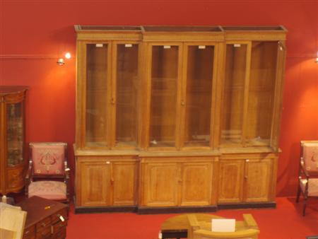 Appraisal: A large oak breakfront bookcase the projected moulded cornice over