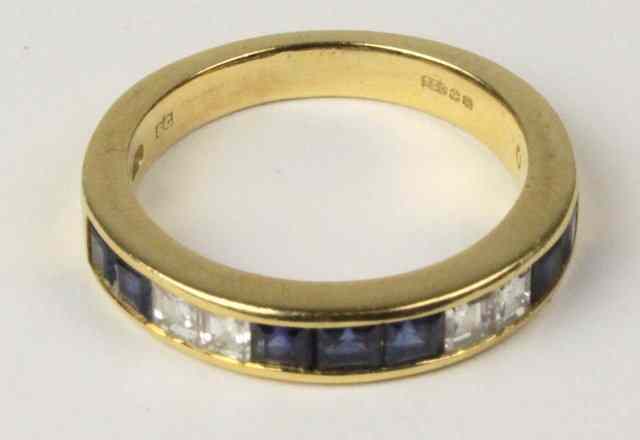 Appraisal: A sapphire and diamond half eternity ring in an ct