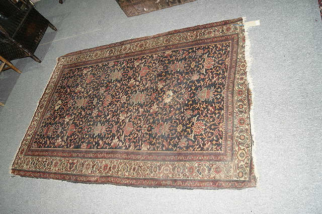 Appraisal: A CAUCASIAN BLUE GROUND RUG decorated with Chinese urn designs