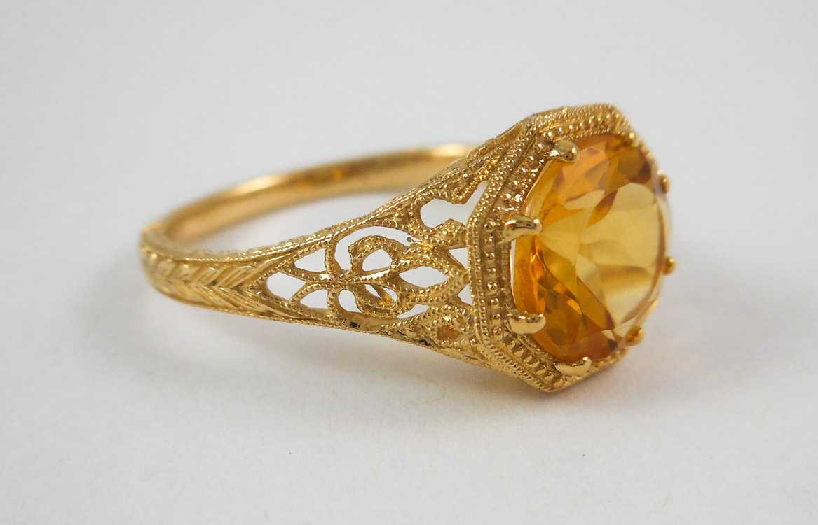 Appraisal: CITRINE AND FOURTEEN KARAT GOLD RING The yellow gold filigree