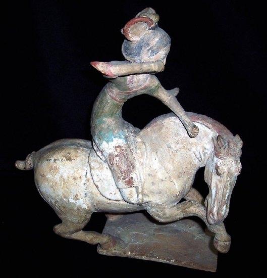 Appraisal: A Tang painted pottery figure of a polo player astride