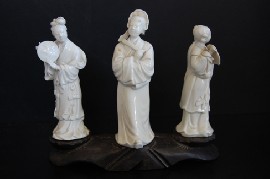 Appraisal: SET OF THREE BLANC DE CHINE FIGURES ON WOODEN STAND