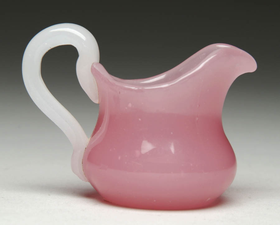 Appraisal: STEUBEN MINIATURE CREAMER Lovely Steuben miniature creamer is rosaline glass