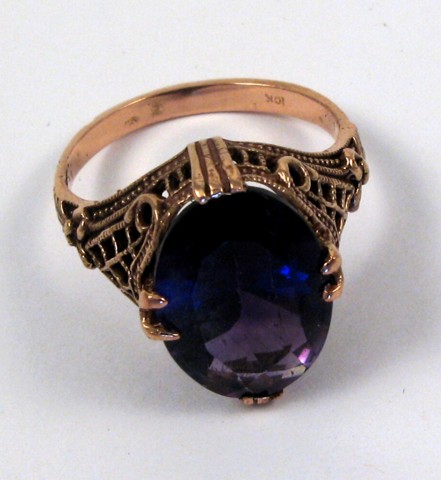 Appraisal: AMETHYST AND TEN KARAT ROSE GOLD RING centering an oval-cut