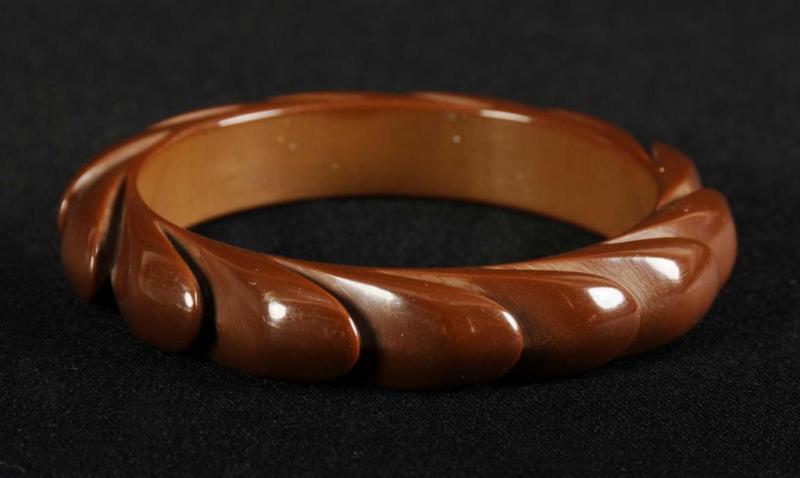 Appraisal: Bakelite Deeply Carved Brown Wave Carved Bracelet Condition Excellent Size